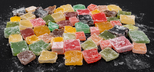 Assorted delicious Colorful Turkish Delights on dark background
