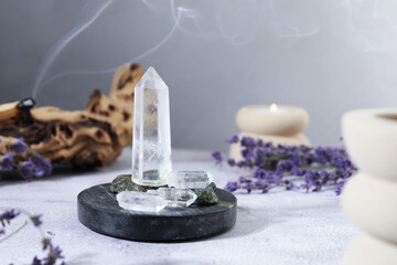 Aura. Different crystals, lavender, burning candle and Palo Santo on white textured table, closeup
