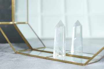 Aura. Beautiful crystal on white textured table, closeup. Space for text