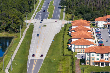 Apartment-style condominiums in Florida suburbs, surrounded by greenery and designed for modern...