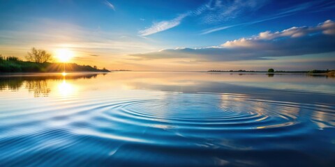 Fototapeta premium Serene Sunrise Over Calm Water with Gentle Ripples Reflecting the Golden Hour Sky