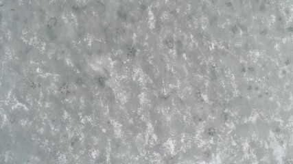 Top-down perspective of shattered ice floes drifting on dark water. - Powered by Adobe