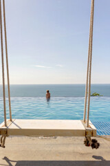 Child with mother in swimming pool, enjoying hppy family summer vacation on the beach and in resort