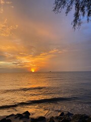 Golden Hour Sunset Over Ocean Waves with Rocky Shore