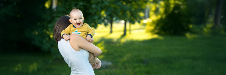 Happy Baby and Mother in Park Wide Banner