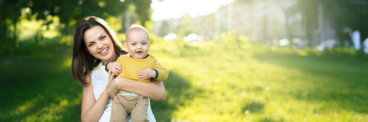 Smiling Mother and Baby in Sunny Park Wide Banner