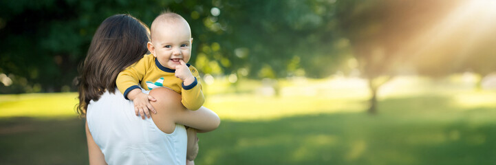 Baby on Mother's Shoulder in Sunny Park Wide Banner