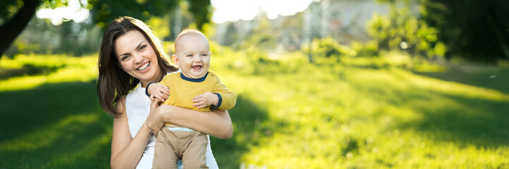 Happy Mother and Baby in a Sunny Park Wide Banner