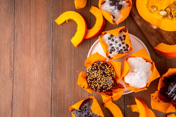 Tasty autumn chocolate pumpkin cupcakes, chocolate and sugar glazed muffins with various fillings,...