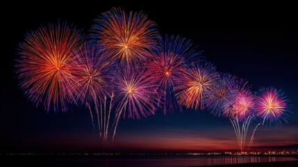 Vibrant Fireworks Display Over Calm Water at Night Sky