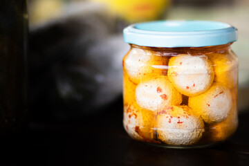 Labneh, a creamy Middle Eastern strained yogurt cheese, in a clear glass jar placed on a rustic...