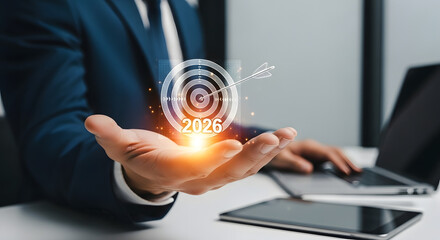 Businessman holding a glowing digital target with data connections