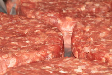 Close up of raw burgers waiting to be fry cooked beef meat