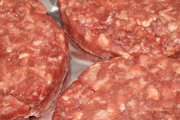 Close up of raw burgers waiting to be fry cooked beef meat