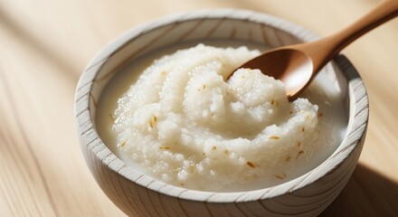 Japanese fermented rice porridge, amazake, in a wooden bowl with spoon