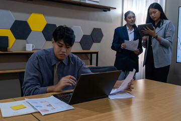 Team collaboration in a modern office during a business meeting focused on project development and...