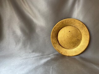 gold plate  on a grey  background