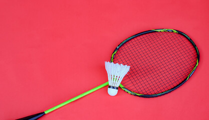 Shuttlecock and Racket on Red Background