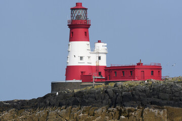 Red and white lighthouse on the Farne Islands, Northumberland, UK