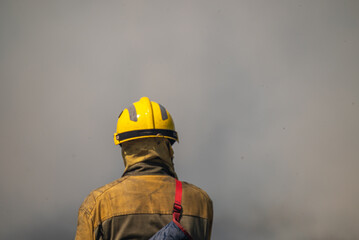 The Silhouette of a Fireman in a Dense Fog. Concept Bravery in zero visibility.
