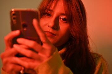 young woman with a mobile phone. blogger girl. emotions with smart phone