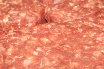 Close up of raw burgers waiting to be fry cooked beef meat
