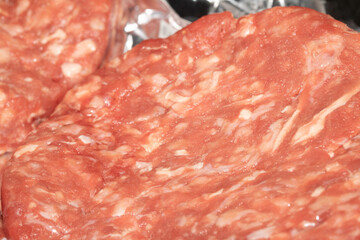 Close up of raw burgers waiting to be fry cooked beef meat
