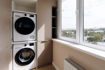 A Modern Laundry Space Featuring a WasherDryer Combo and Abundant Natural Light