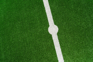 the line on a perfect green grass in soccer stadium. Close up midfield with center point.