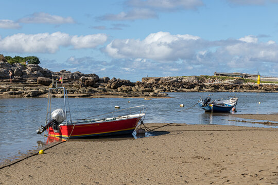 Santander, Spain. La Maruca beach with boats stranded on the sand at low tide under the summer sun