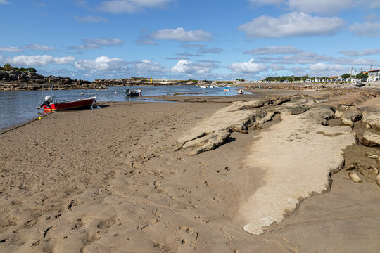 Santander, Spain. La Maruca beach with boats stranded on the sand at low tide under the summer sun