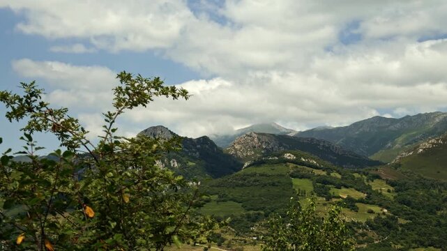 Clouds drifting over green mountain landscape