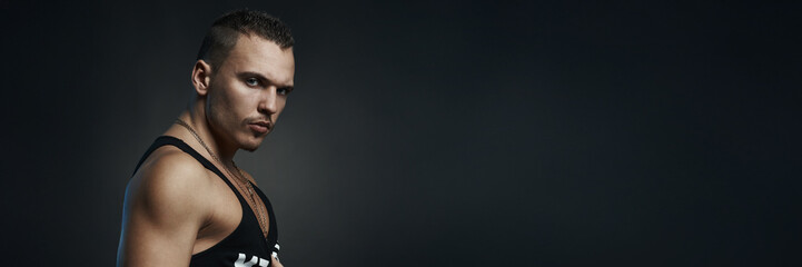 Confident Man Portrait in Dark Wide Banner with Copy Space