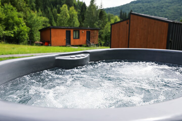 Tub with hot water at luxury resort in mountains, closeup