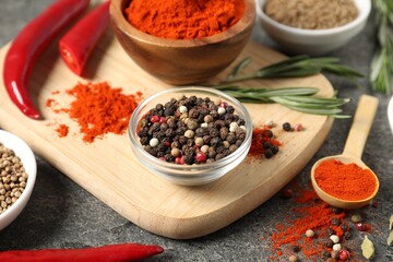 Different aromatic spices on grey table, closeup