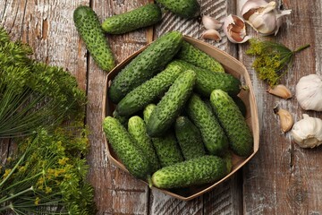 Making pickles. Fresh cucumbers and spices on wooden table, flat lay