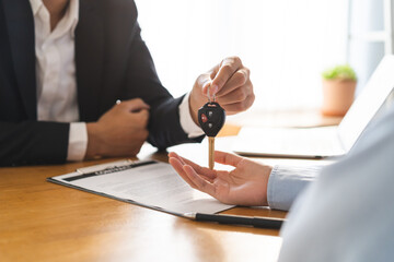 Business car rental, sell service, dealership hand of agent dealer, sell asian young male giving...