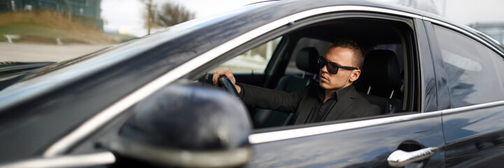 Man Driving Car in Sunglasses Wide Banner