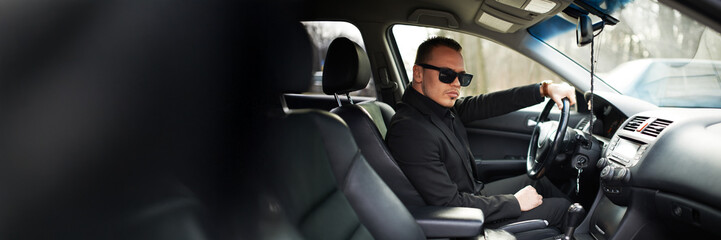 Confident Man Driving in Car Wide Banner
