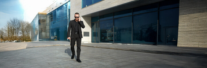 Businessman Walking with Phone Wide Banner with Copy Space