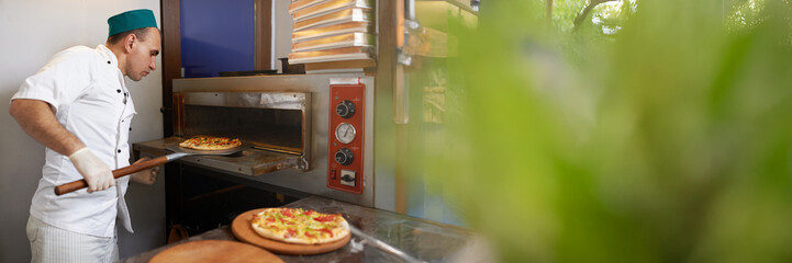 Chef Preparing Pizza in Wide Banner with Copy Space