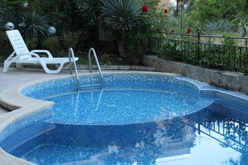 Outdoor swimming pool and different green plants