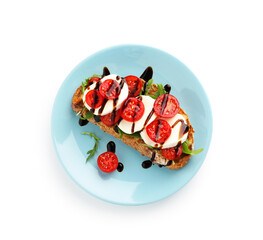 Delicious sandwich with mozzarella cheese, balsamic sauce, tomato and arugula isolated on white, top view