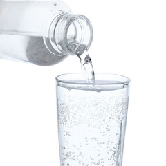 Pouring refreshing soda water from bottle into glass on white background, closeup