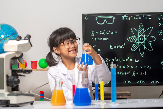 Young Scientist's Experiment: A young, enthusiastic scientist engages in a captivating science experiment, meticulously observing colorful liquids within lab glassware, embodying curiosity.
