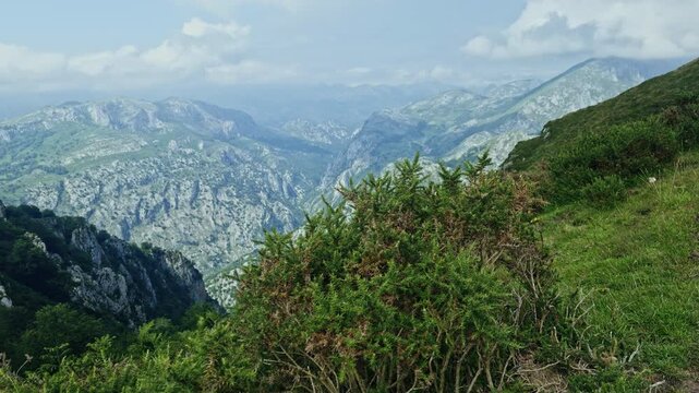 Clouds drifting over rugged mountain range landscape
