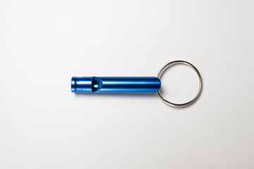 Closeup view of a blue whistle isolated over a white background