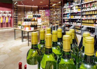 defocused alcohol (wine, champagne, liquor, whiskey) on store shelves