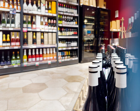 defocused alcohol (wine, champagne, liquor, whiskey) on store shelves