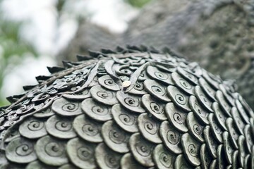 The scales of a large dragon at a Buddhist temple, where people go to pray for luck in the lottery.